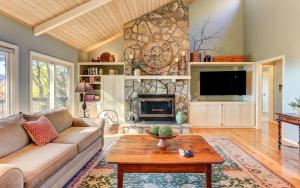 a living room with a couch and a fireplace at Vista Haven - Mountain Views and Fireplace and Big Screen TVs and Extras in Jasper