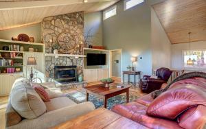 a living room with a couch and a fireplace at Vista Haven - Mountain Views and Fireplace and Big Screen TVs and Extras in Jasper