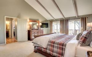 a bedroom with a bed and a television in it at Vista Haven - Mountain Views and Fireplace and Big Screen TVs and Extras in Jasper