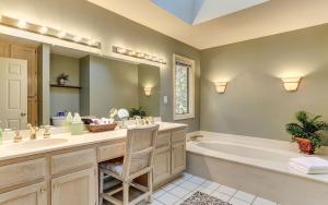 a bathroom with a tub and a large mirror at Vista Haven - Mountain Views and Fireplace and Big Screen TVs and Extras in Jasper