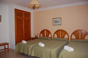 Postel nebo postele na pokoji v ubytování Hotel Antonio Conil