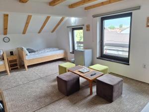 a living room with a bed and a table at Casa Oaspeti Transfagarasan in Cârțișoara
