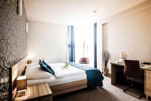 A bed or beds in a room at Hotel Deluxe with free Wellness and Fitness Centrum