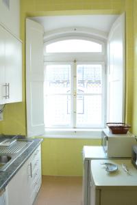 a kitchen with a window and a microwave at Fantastic Downtown New Apartment in Lisbon