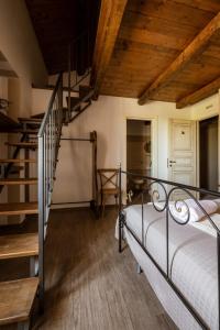 a bedroom with a metal bed and a staircase at Locanda Mammi in Agnone