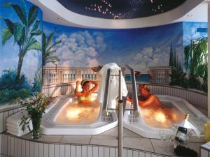 two women in hot tubs in a hotel room at Sporthotel Krone in Schoppernau
