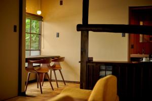 a kitchen with a table and chairs in a room at 海月 うみづき in Tomo