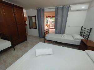 a bedroom with two beds and a door to a patio at Casa vacanze La canzone del sole in Torre Squillace