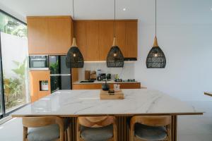 a kitchen with a island with a counter top at Modern 3BR Private Pool Villa 5-min Beach in Canggu