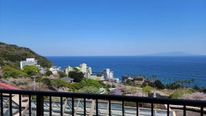 a view of the ocean from a balcony at Itoen Hotel Atagawa in Higashiizu