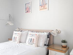 a bedroom with a bed with white sheets and pillows at Hendon Street En-suite Homestay Rooms Nr Beach & Walk to Cafes in Brighton & Hove