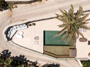 an overhead view of a building with a palm tree at Villa Lilium II - Sanctuary overlooking Psarou Bay in Psarou