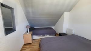 a small bedroom with a bed and a window at Arzon in Arzon