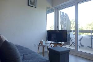 a living room with a couch and a flat screen tv at Arzon in Arzon