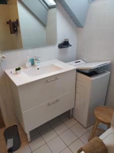 a bathroom with a white sink and a mirror at Arzon in Arzon