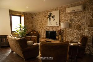 a living room with two chairs and a television at Casa da Trapa in Oliveira de Azemeis