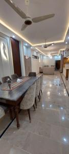 a large room with a long wooden table and chairs at Tranquil 2BR Portion Gulistan e Joher BLK 14 in Karachi +11 photos
