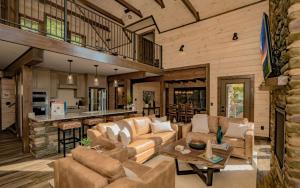 a living room with couches and a kitchen at Smoky Mountain Skies in Gatlinburg