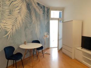 a dining room with a table and chairs at Apartament Niebieski Lwowska 56 in Nowy Sącz +16 photos
