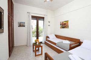 a small room with a bed and a couch at Cozy apartment in Polychrono in Polykhrono