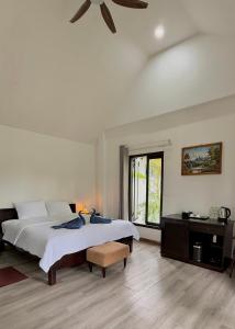 a bedroom with a bed and a ceiling fan at Nos Vetra Resort in Phú Quốc