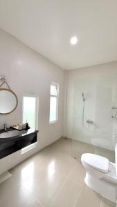 a bathroom with a toilet and a sink and a shower at Nos Vetra Resort in Phú Quốc +40 photos