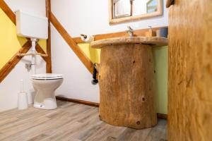 y baño con lavabo de madera y aseo. en Sobe na skednju, en Bohinjska Bistrica