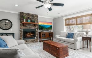 a living room with a couch and a fireplace at Cottage On The Ridge in Sevierville