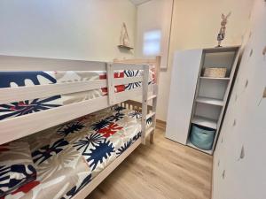a bedroom with two bunk beds and a shelf at Casa con vistas en Bueu in Bueu