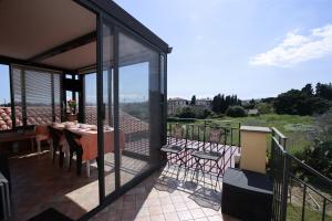 a balcony of a house with a table and chairs at la circumetnea rooms in Catania