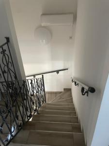a stairway with a stair railing at Anett Wellis Apartman Poroszló in Pusztavacs