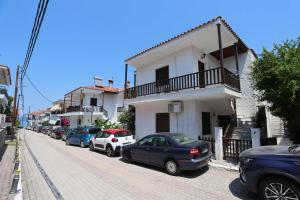 a row of cars parked on the side of a street at Cozy apartment in Polychrono in Polykhrono
