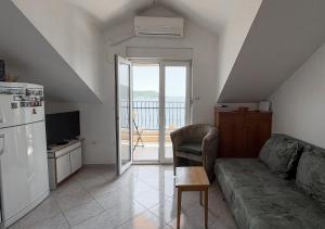 a living room with a couch and a refrigerator at The View Savina - Herceg Novi in Herceg-Novi