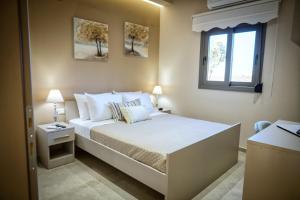 a bedroom with a large bed with a window at Secluded Luxury Villa w Jacuzzi & Stunning Views in Kali Limenes