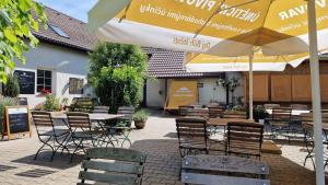 a patio with tables and chairs and an umbrella at Apartment Drahuska in Prague