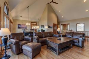 a living room with leather furniture and a table at Starry Nights - Unforgettable Views Steamy Hot Tub Game Room More in Jasper