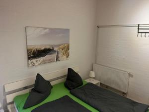 a bedroom with a bed and a picture of a beach at Schwalbennest in Tossenserdeich