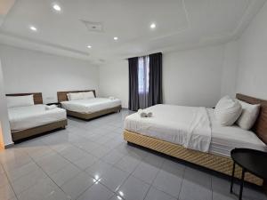 Postel nebo postele na pokoji v ubytování T Hotel Tandop