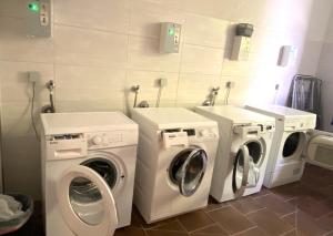 two washing machines and two washers in a bathroom at Rennsteighostel in Ruhla