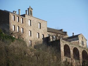 an old brick building on top of a hill at Les Hauts de Camarès in Camarès