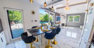 a dining room with a table and chairs at Holiday Home Nova Lux in Mostar +73 photos