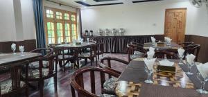 a dining room with wooden tables and chairs at Adventure Sarai Skardu in Skardu