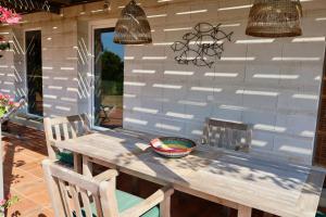 a wooden table and chairs on a patio at Mar y Emma in Vall-Llobrega