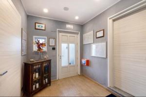 a hallway with a white door and a window at Villa Giulia - Marguareis in Peveragno