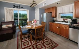 a kitchen with a table and a refrigerator at The Smoky Mountain Nest in Pigeon Forge