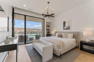 a bedroom with a bed and a couch and a window at Luxury Beachside home in St. George