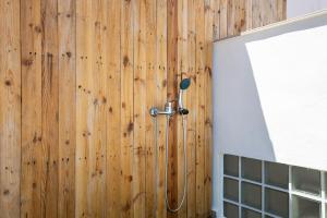 a shower in a bathroom with a wooden wall at Atlantic Sunrise in Santa Cruz de Tenerife +23 photos