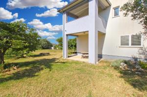 a house with a large window on the side of it at Apartments Tamara 2397 in Fažana