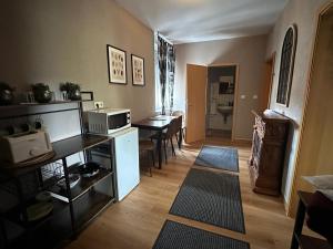 a living room with a kitchen and a table with a microwave at Pension Stadt Mannheim in Mannheim +9 photos