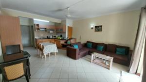 a living room with a couch and a table at Residence Les Peupliers 05-06 in Flic-en-Flac